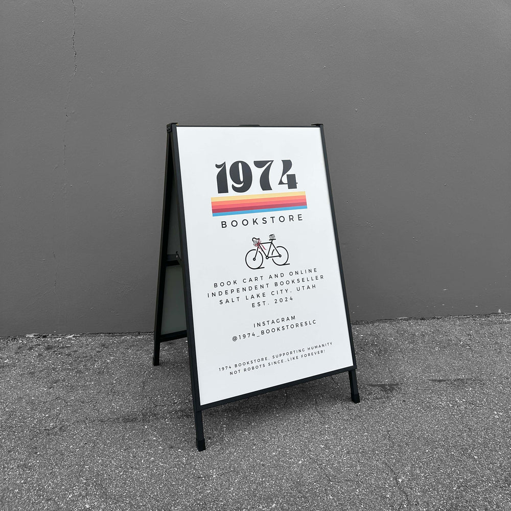 A-frame sign for 1974 Bookstore against a gray wall.