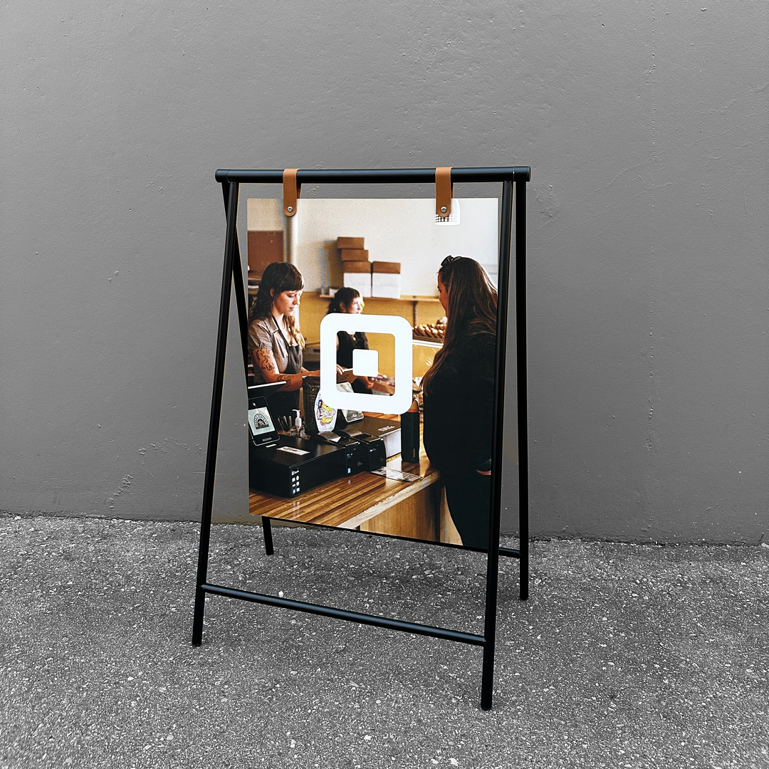 Framed photo of a woman working at a desk with a gray wall background